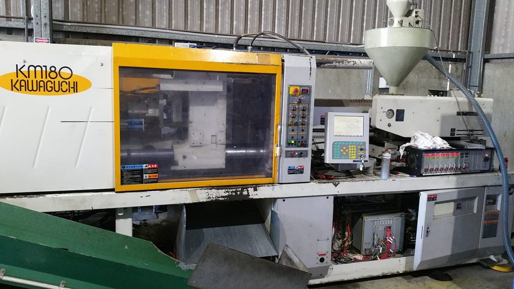 Close up view of plastic moulding machinery